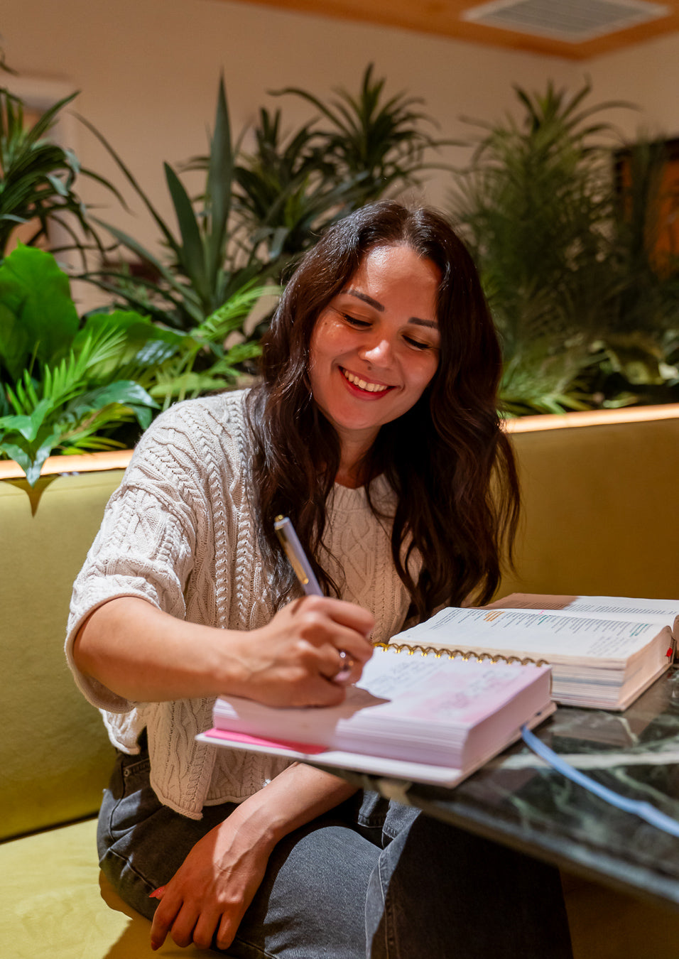 Miriam writing in the Be Transformed journal